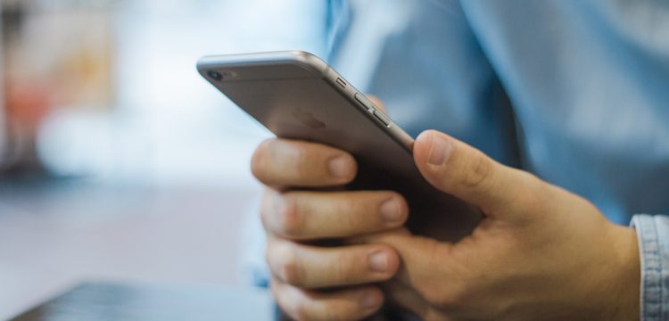 Hand holding an iPhone